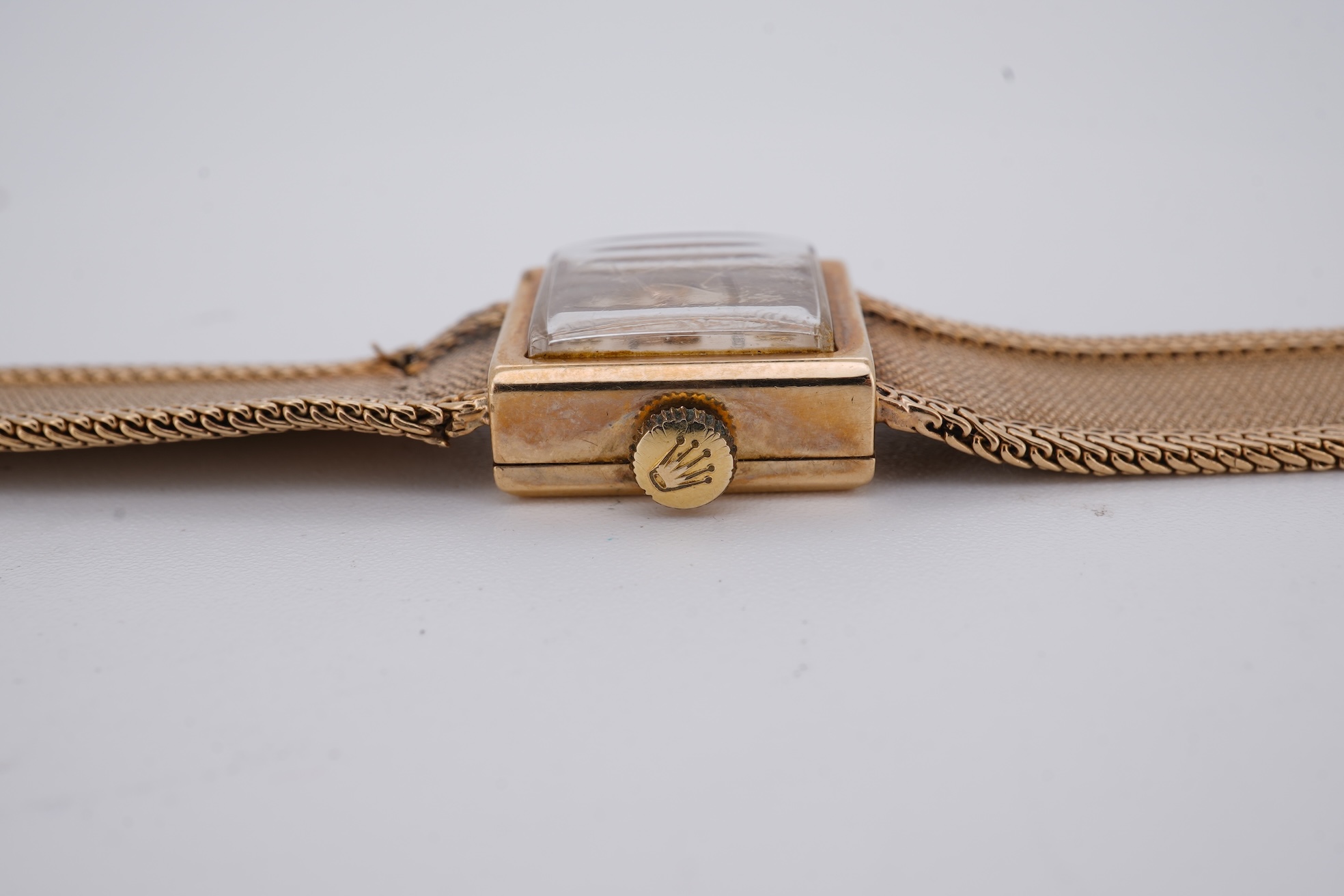 A lady's 1960's 9ct gold Rolex Precision manual wind wrist watch, with square dial, on an integral 9ct gold bracelet, the clasp with Rolex crown, overall length 15cm, gross weight 22 grams (bracelet a.f.)